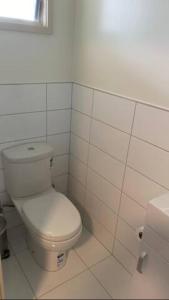 a white bathroom with a toilet and a window at Home Away from Home - Waitaki Lakes Apartment A5 in Otematata