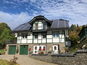 a house with solar panels on the roof at Wanderstube Landsonne in Simmerath