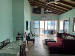 a living room with a red couch and a table at Sunset View in Bastimentos