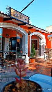a restaurant with a patio with tables and chairs at Ñaupa House Hostel in Cochabamba