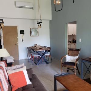 a living room with a couch and a table at Apartamento en Complejo Arcobaleno in Punta del Este