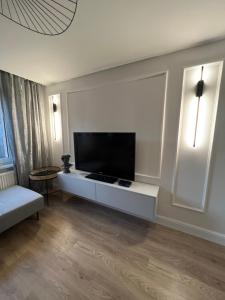 a living room with a flat screen tv on a wall at Igart Studio in Leszno