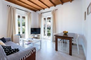 a living room with a couch and a table at Tati Apartment in Kassiopi