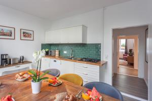 a kitchen with a wooden table and a dining room at The Paul II - stylish & central 3 BR apartment, group & family friendly, 4- 6 Guests in Berlin