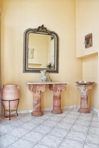 W łazience znajduje się umywalka i lustro. w obiekcie Mema's Apartment w mieście Agia Efimia