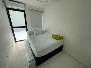 a small bed in a room with a window at Vista Al Mar, Aire Acondicionado en Todo el Apto, Wi-Fi, Parqueadero in Cartagena de Indias +23 photos