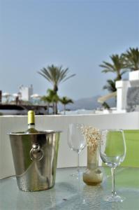 two wine glasses and a bucket on a table at Apartamento Martina in Puerto del Carmen