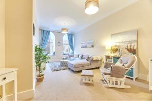 a living room with a couch and a chair at A *Spacious* 3 Bedroom Flat - Town Centre Berwick Upon Tweed in Berwick-Upon-Tweed