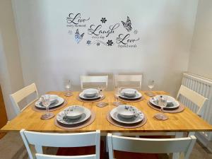 a dining room table with chairs and a table and a table and chairsktop at A *Spacious* 3 Bedroom Flat - Town Centre Berwick Upon Tweed in Berwick-Upon-Tweed +9 photos