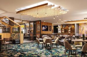 a rendering of a restaurant with tables and chairs at 1 Martello Beach 8 berth holiday home with pools in Clacton-on-Sea