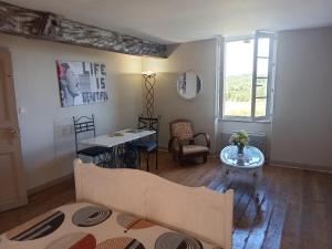 a living room with a couch and a table at Bâtisse historique proche Lac et forêts in Savères