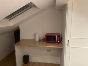 a microwave sitting on a counter in a room at Spacious loft space with private en-suite bathroom in London