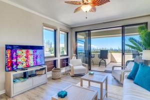 a living room with a large flat screen tv at K B M Resorts- KGV-17T5 Remodeled 1Bdrm villa extra-large balcony sweeping ocean views in Kapalua