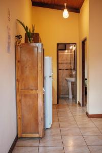 a kitchen with a refrigerator in a room at Estrella del Monte in Puerto Iguazú