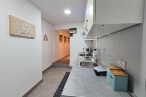 a kitchen with a sink and a counter top at Luxury 1 bedroom flat in the heart of Wood Green in London