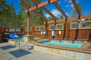 a swimming pool in a house with a wooden wall at Townhome Four O'Clock in Breckenridge
