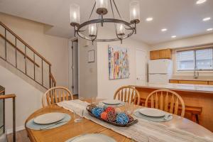 a dining room table with a bowl of fruit on it at Townhome Four O'Clock in Breckenridge