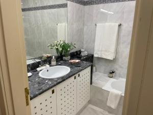 a bathroom with a sink and a tub at Apartamento Mimi in Figueira da Foz