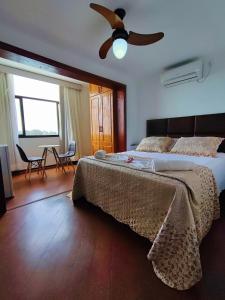 a bedroom with a bed and a ceiling fan at Marambaia Mar in Rio de Janeiro