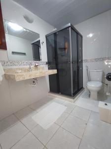 a bathroom with a shower and a toilet in it at Marambaia Mar in Rio de Janeiro
