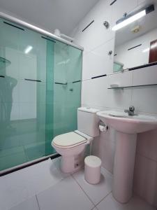 a bathroom with a toilet and a glass shower at Marambaia Mar in Rio de Janeiro