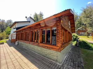 a building with a sign on the side of it at Ciprés Lago Futaláufquen in Esquel +12 photos