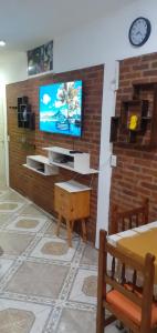 a living room with a tv on a brick wall at Rowina Inn 1 in Tigre