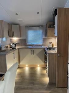 a kitchen with a sink and a counter top at Coghurst Hall Holiday Home Sleeps 6, 2 bedrooms in Hastings
