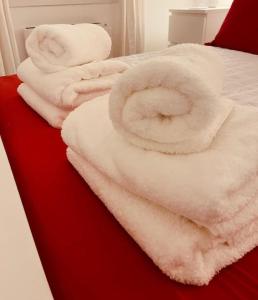 a bed with white towels on top of it at Beautiful refurbished, self-contained apartment in Fife