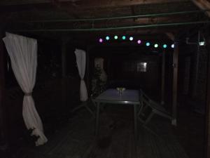 a dark room with a table and a curtain at Longère Bretagne in Réminiac