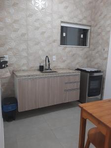 cocina con fregadero y encimera en Apartamento Confortável Perto da Praia, en Cabo Frío