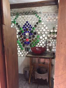 a wall with a bunch of glass bottles on it at Casa Hobbit in Salinas