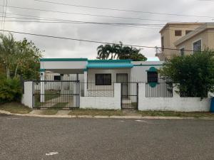 a white house with a blue roof at Hanas paradise in San Felipe de Puerto Plata