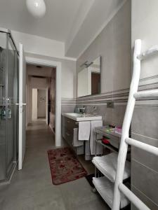 a bathroom with a sink and a mirror at Design apartment n. 41 in Trento