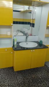 a bathroom with a sink and a mirror at Maison de campagne proche des plages in Sainte-Rose