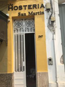a door to a building with a sign on it at Hosteria San Martin in San Salvador de Jujuy