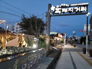 a statue of a cow on the side of a street at Jeju Vision House in Jeju
