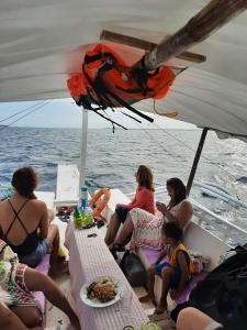 a group of people sitting on the back of a boat at Jao bay boat charter in Talibon