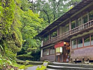 a building with a balcony on the side of it at Shokinkan in Yasugi