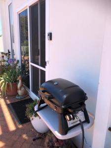 a grill sitting on a table outside of a house at H&H studio overlooking Boston Bay, Port Lincoln in Port Lincoln