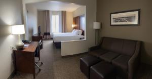a hotel room with a couch and a bed at Rapid River Lodge in Baxter