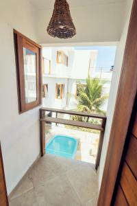 - une vue sur la piscine depuis le balcon d'une maison dans l'établissement Apartamento Manay, à Jericoacoara