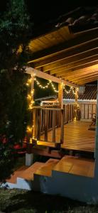 a wooden deck with lights on it at night at CABAÑAS LOS LAURELES in Huasca de Ocampo