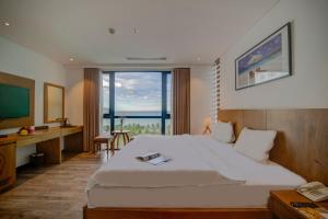 a hotel room with a bed and a large window at Soho Boutique Hotel in Danang