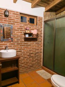 a bathroom with a sink and a glass shower at CABAÑAS LOS LAURELES in Huasca de Ocampo