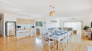 a kitchen and living room with a table and chairs at Sienna by the Sea in Callala Beach