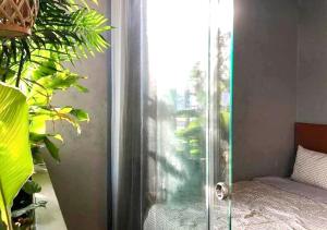 a glass door leading to a patio with plants at 5-homestay I in Vung Tau