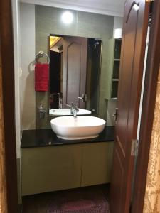 a bathroom with a white sink and a mirror at Sajhome Fortkochi, Kochi, Kerala, inda in Cochin