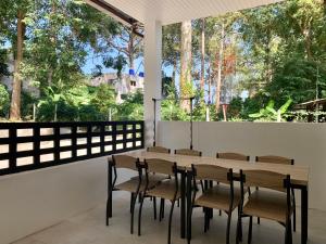 uma sala de jantar com mesa e cadeiras e uma grande janela em Island House Rentals 25 em Ko Samet