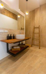a bathroom with a sink and a mirror and a ladder at 8 Palm Villa - Private Pool Villas in Aonang in Ao Nang Beach